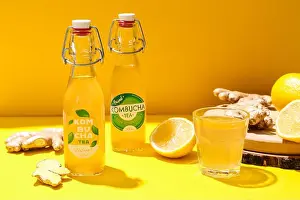 Vitamin Water Prints: Glass and bottles of fresh kombucha on color background