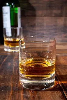 Lowlands Prints: Glasses of strong scotch single malt whisky served on dark wooden table in old pub