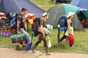 Tents Prints: Glastonbury Festival fans and festival goers arrive with their backpacks