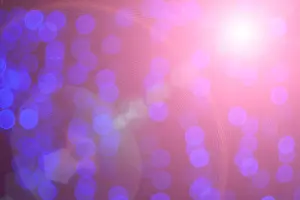 Glittering Prints: glittering stars on bokeh with a highlight. Christmas background
