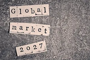 Typewriter Prints: Global market 2027 concept words cut from paper on rough