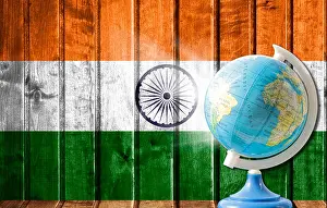 Globe with a world map on a wooden background with the image of the flag of India