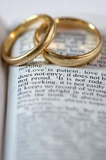 St Paul Prints: Two gold wedding rings lie on an open Bible. The verses are from 1 Corinthians 13