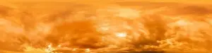 Golden glowing red orange overcast sunset sky panorama