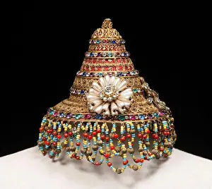 A golden metal helmet adorned with turquoises