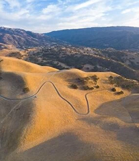 Aerial Landscape Collection: Golden sunlight shines on the rolling hills in Northern California. These beautiful