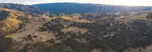 Golden sunlight shines on the rolling hills in Northern California. These beautiful, eroded hills turn green once winter brings seasonal rain