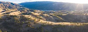 Golden sunlight shines on the rolling hills in Northern California. These beautiful, eroded hills turn green once winter brings seasonal rain