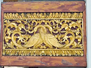 Peacock Prints: golden wooden carving of peacocks, Wat Phrathat chomkitti temple in Chiang rai, Thailand