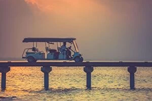Images Dated 7th January 2017: Golf cart at Maldives island at Luxury resort villas, sunset landscape