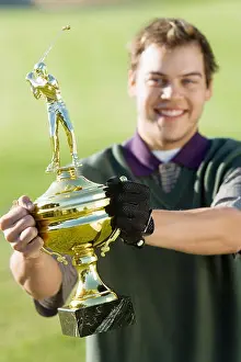Late 20s Prints: Golfer Holding Tournament Trophy