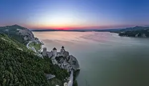 Serbian Prints: Golubac fortress castle walls standing on Danube river bank in sunset rays aerial panorama