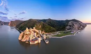 Serbian Prints: Golubac fortress castle walls standing on Danube river bank in sunset rays aerial panorama