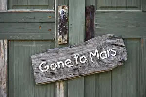 Pursuit Prints: Gone to Mars planet sign on old green doors