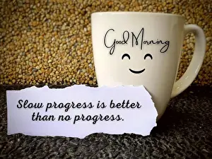 Perseverance Prints: Good morning text on a coffee cup with motivational quote on a piece of paper - slow progress is better than no