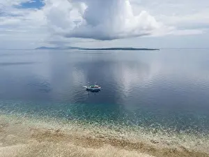 Coral Triangle Prints: A gorgeous coral reef surrounds the remote island of Koon in the Banda Sea of Indonesia