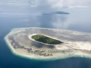 A gorgeous coral reef surrounds the remote island of Koon in the Banda Sea of Indonesia. This tropical region is known for its marine biodiversity
