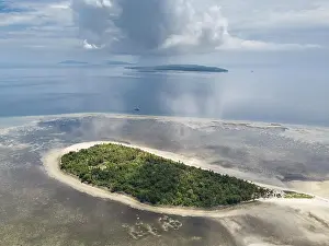 A gorgeous coral reef surrounds the remote island of Koon in the Banda Sea of Indonesia. This tropical region is known for its marine biodiversity