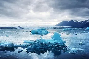 Blue Ice Prints: Gorgeous evening landscape with floating icebergs in Jokulsarlon glacier lagoon, Iceland