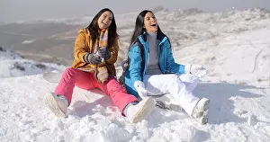 Snowboard Prints: Two gorgeous laughing young woman in snow