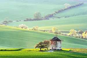 Gorgeous rural landscape with old windmill and green sunny spring hills. South Moravia region, Czech Republic