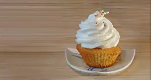 Vanilla Prints: Gourmet Cupcake with White Creamy and Colored Sprinkles