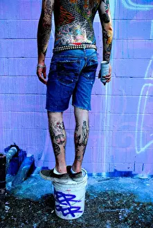Belt Prints: Graffiti artist with tattoos paints in Austin Texas