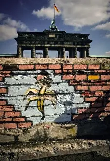1990 Prints: Grafitti of a banana at a section of the Berlin Wall in front of the famous Brandenburg Gate in spring of 1990