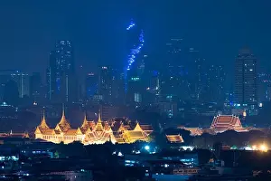 Grand palace bangkok with bangkok city skyscrapers at night in Bangkok, Thailand