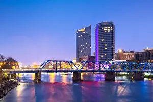 Grand Rapids, Michigan, USA downtown skyline on the Grand River at dusk