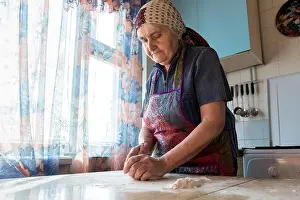 Housework Prints: Grandmother cooking in the kitchen, kneading dough for bakery
