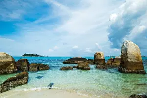 Dramatic Sky Prints: Granite boulders and clear turquoise water at Tanjung Tinggi beach