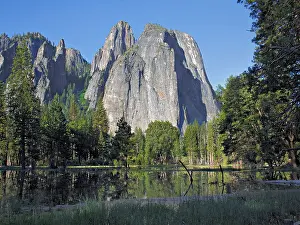 Reflecting Prints: Granite mountain with pine trees and reflection on water in the foreground