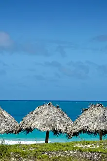 Havana Prints: grass palapas on the beach with sunny blue skys and tropical waters