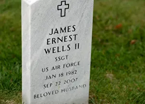 Volunteers Prints: The grave marker of Air Force Staff Sergeant James Ernest Wells II is displayed at Arlington National Cemetery