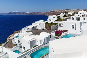 Cyclades Prints: Greek architecture - small traditional white houses on the coastal cliff.