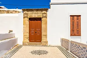 Whitewashed Prints: Greek architecture with traditional doors and decorative pavement in Lindos town