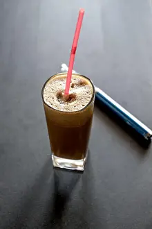 Mocha Prints: Greek coffee and electronic cigarette on table. Natural light