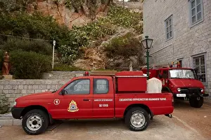 Firefighter Prints: Greek fire brigade department cars outside fire station. Hydra Greece