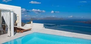 Images Dated 26th July 2021: Greek island of Santorini. Amazing travel panorama, white houses, stairs and flowers on the streets