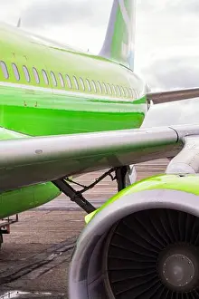 Industries Prints: green airplane and turbine detail on cloudy sky background