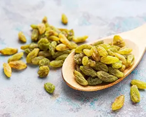 Dietary Prints: Green dried raisins on a grey concrete background