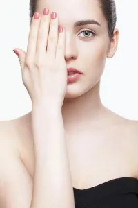 Human Being Prints: Green-eyed young beautiful woman in black dress closing eye by hand
