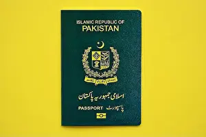 Pakistan Prints: Green Islamic Republic of Pakistan passport on yellow background close up