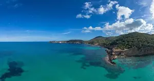 Rocky Coast Prints: The green and rugged hilly coast of northern Ibiza with a view of the turquoise waters of Cala Xarraca bay