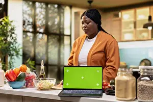 Platforms Prints: Green screen mockup laptop next to african american woman filming food vlog