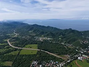 Green shore landscape at pacific ocean with highway road aerial drone view