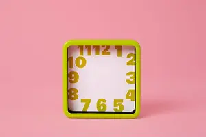 Minute Prints: a green square clock, with green numbers and no hour or minute hands, on a pink background