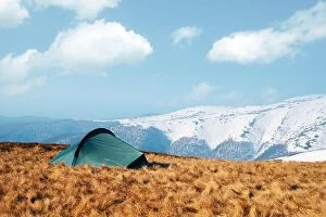 Images Dated 8th April 2019: Green tent on amazing meadow in spring mountains. Landscape photography, travel concept