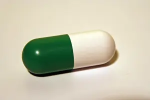 Capsules Prints: Green and white medical pill. Antibiotic capsule